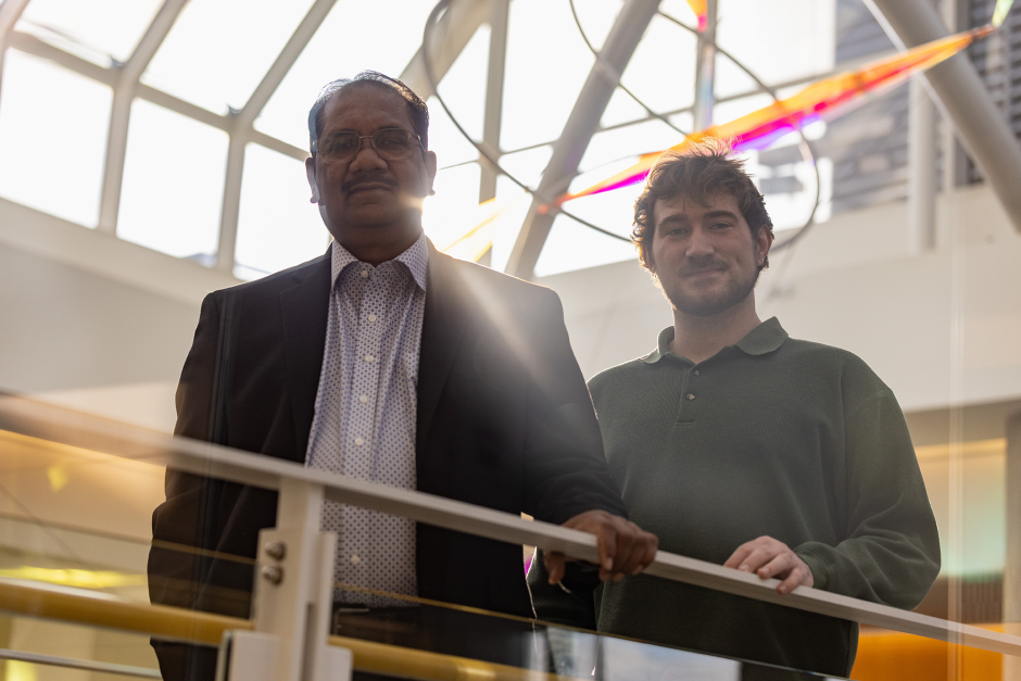 Kamlendra Singh and Steven Ice posing together, looking over a railling